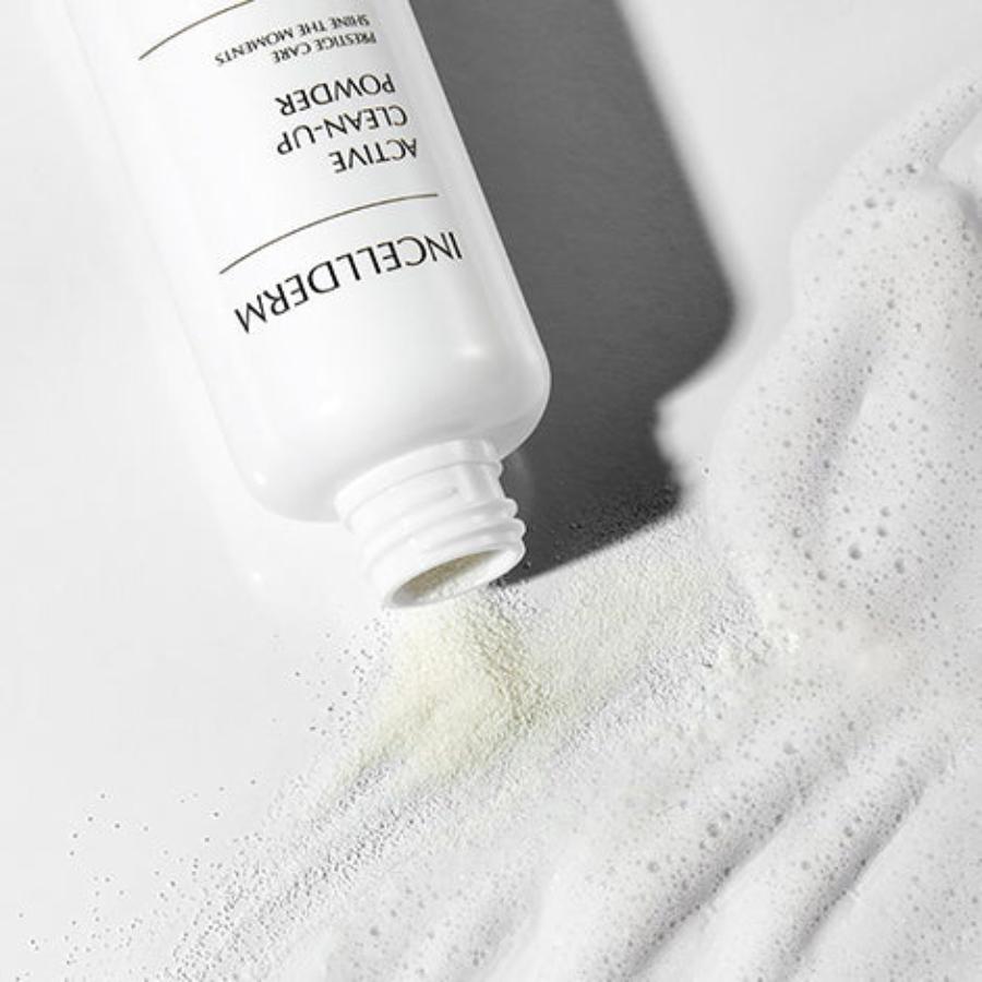 Incellderm Active Clean-Up Powder jar with powder spilling into foamy lather on hands, against a clean, natural backdrop