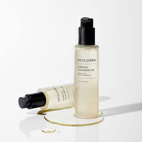 Incellderm Purecell Cleansing Oil bottle with golden oil droplets on clean, glowing skin.