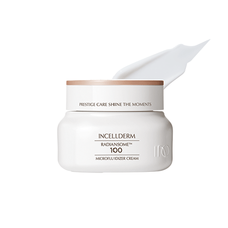 Radiansome™100 Microfluidizer Cream jar with spatula, showcasing a velvety texture against glowing, hydrated skin.