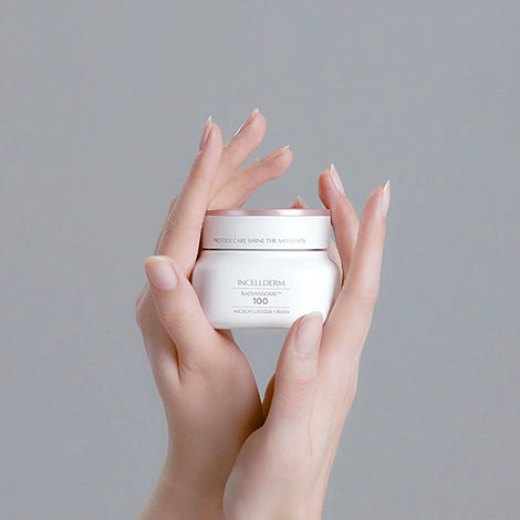 Radiansome™100 Microfluidizer Cream jar with spatula, showcasing a velvety texture against glowing, hydrated skin.