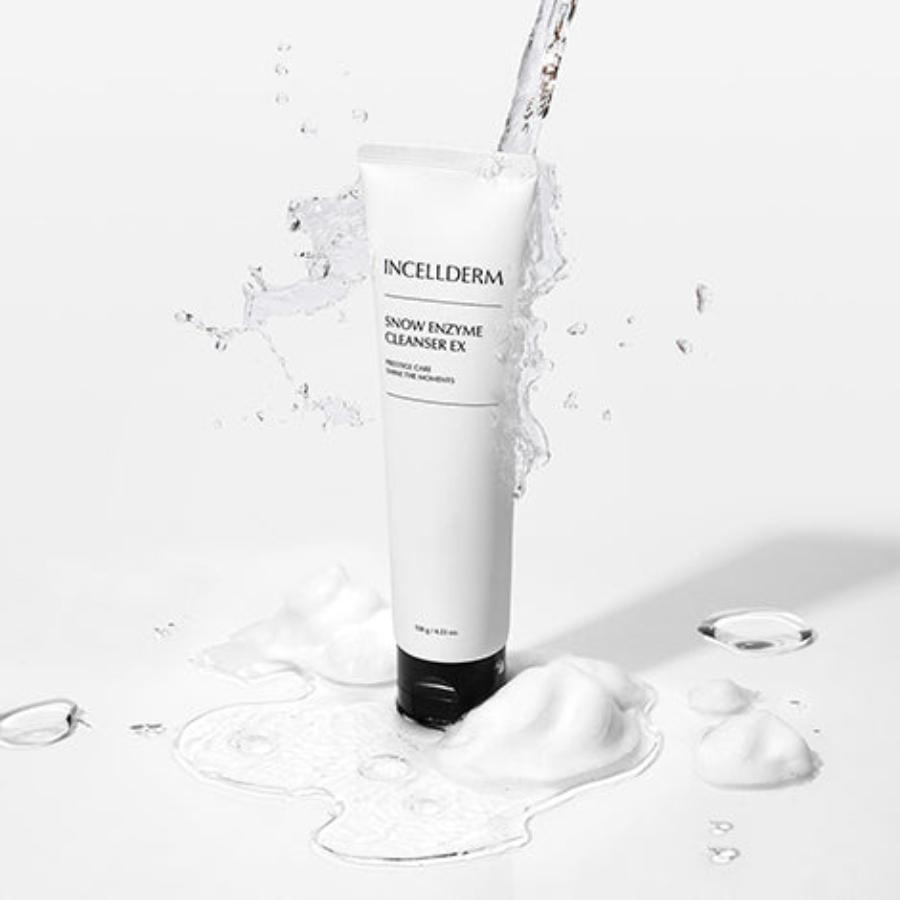 Snow Enzyme Cleanser EX bottle with creamy formula foaming on a brush against a clean, fresh background.