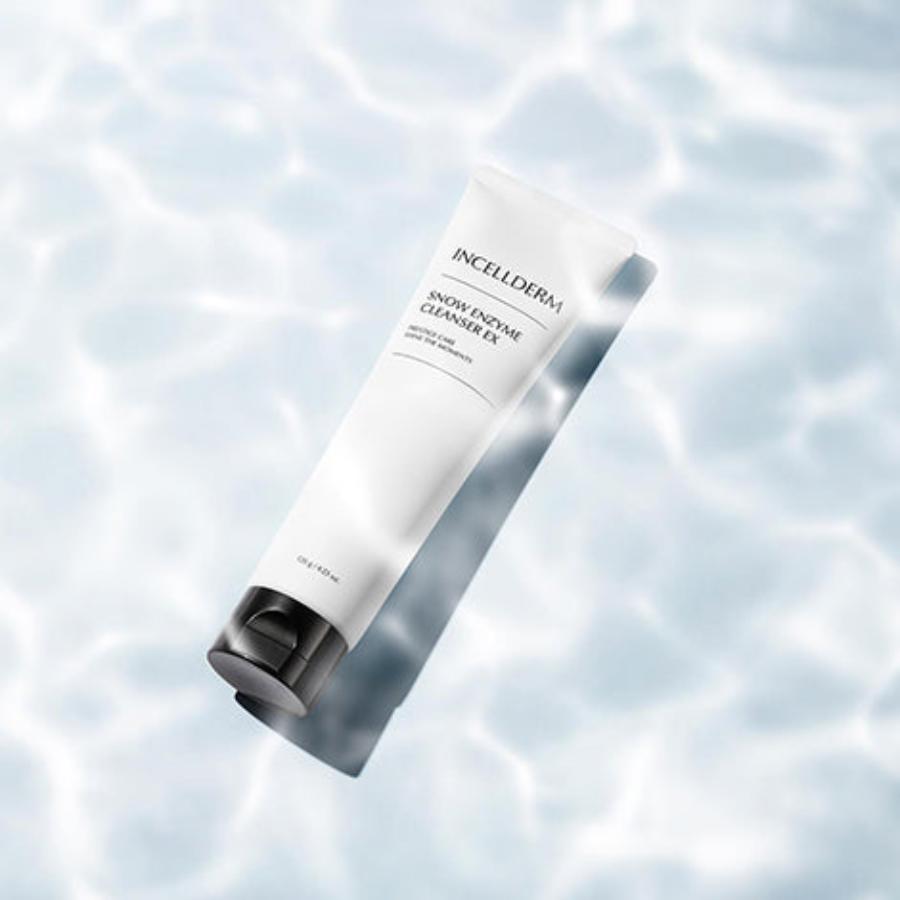 Snow Enzyme Cleanser EX bottle with creamy formula foaming on a brush against a clean, fresh background.