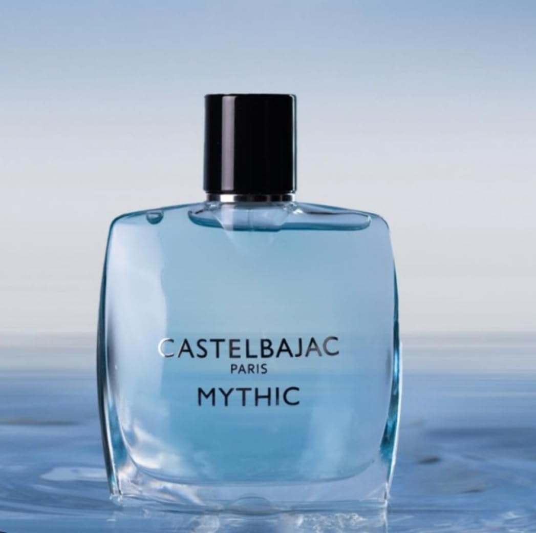 Castelbajac Paris Mythic Eau de Parfum in a sleek blue glass bottle, radiating sophistication against a backdrop of cedar forests and ocean horizons