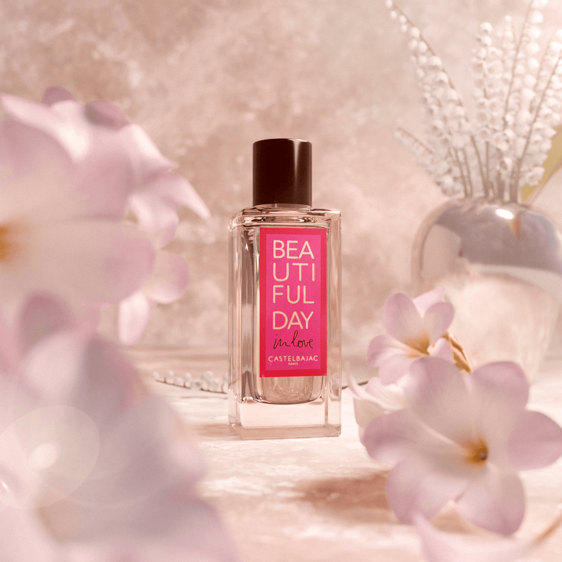 BEAUTIFUL DAY IN LOVE perfume bottle with golden-amber liquid, glowing sensually against a dusky, romantic backdrop
